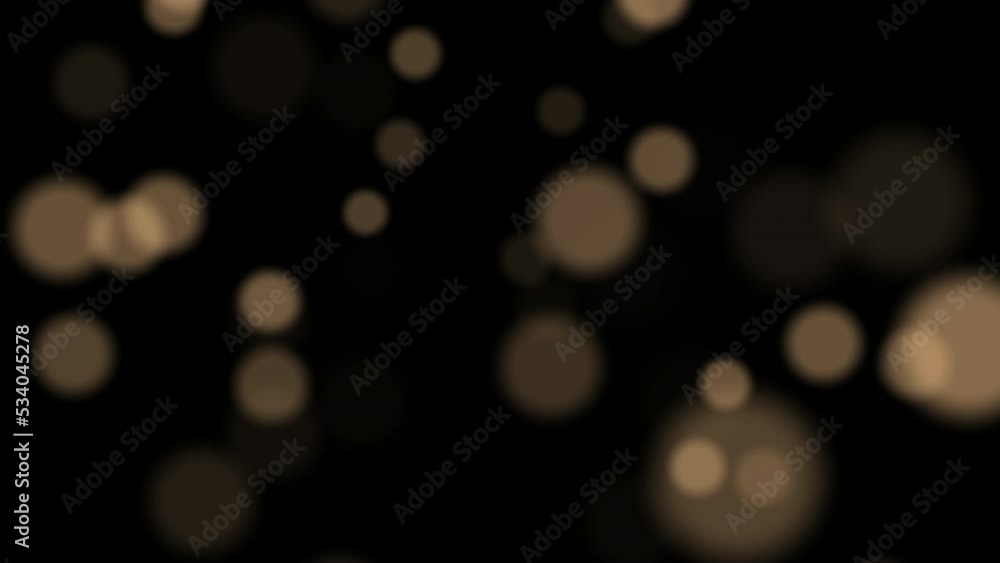 Golden glowing bokeh. Christmas light, bokeh. Blurred motion. Golden Christmas light.