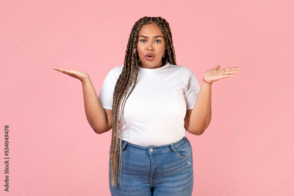 Displeased African American Obese Female Posing Over Pink Background Displeased African American Obese Female Posing Over Pink Background