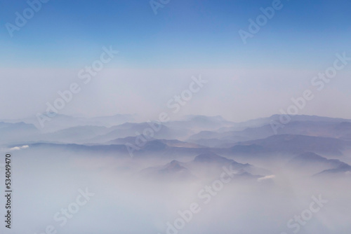 view on volcano and Zagros mountains among clouds photo
