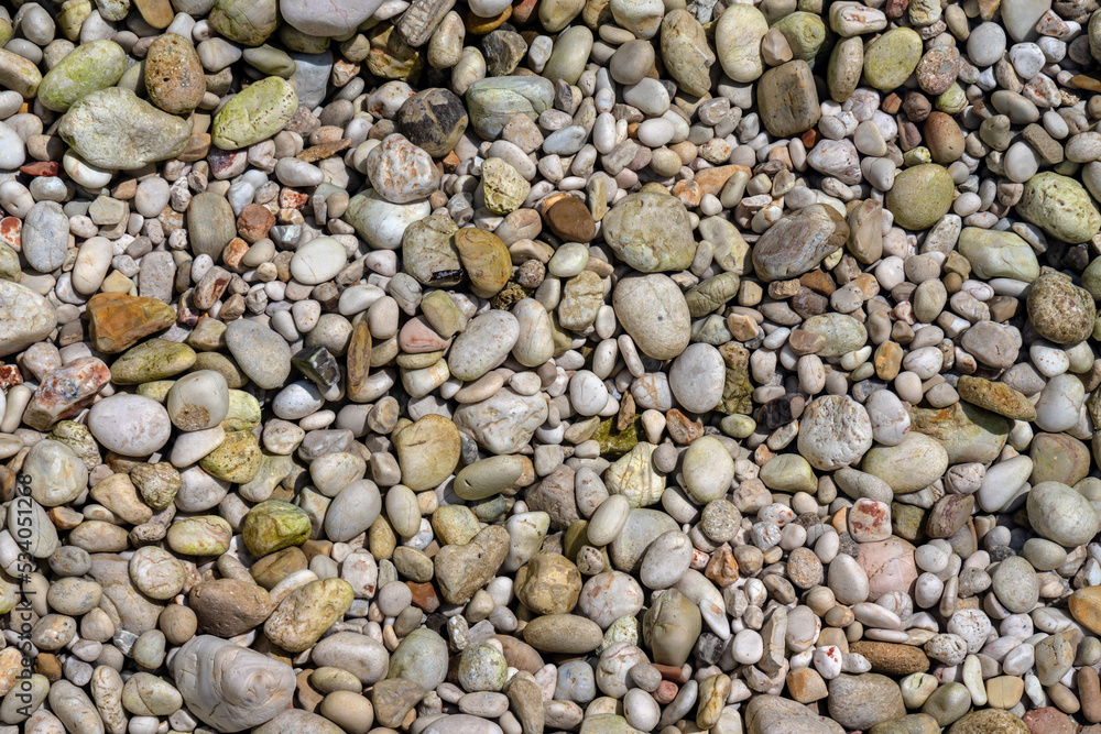 Sun shines to small gravel stones at Limni beach in Corfu, Greece - sea is crystal clear here - rocks in the photo are actually under shallow water Sun shines to small gravel stones at Limni beach in Corfu, Greece - sea is crystal clear here - rocks in the photo are actually under shallow water