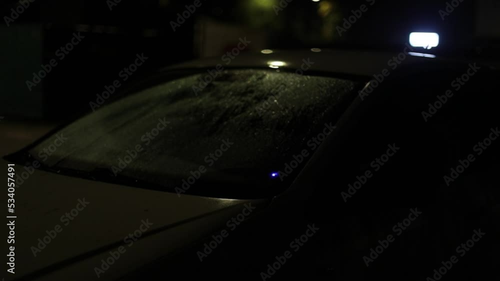 Car in dark in parking lot. Transport costs at night in yard. White car without moving. Evening parking details. Car in dark in parking lot. Transport costs at night in yard. White car without moving. Evening parking details.