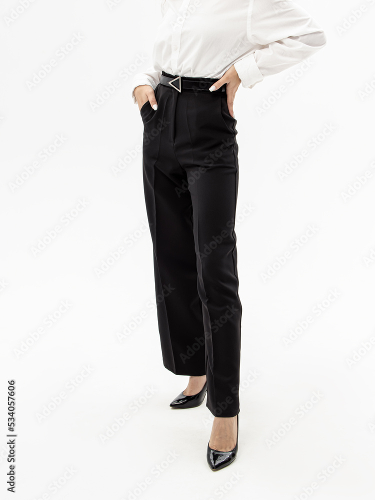 Women s black trousers with belt on white background. Woman in pants white shirt and shoes with heels. Clothes for work college or school Stock Photo Adobe Stock