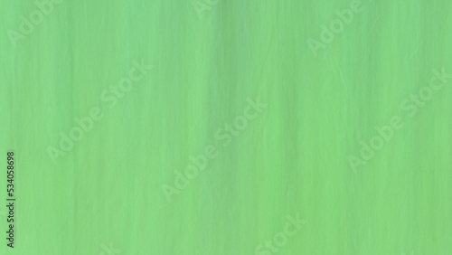 Abstract motion blurred background with vertical lines in green.