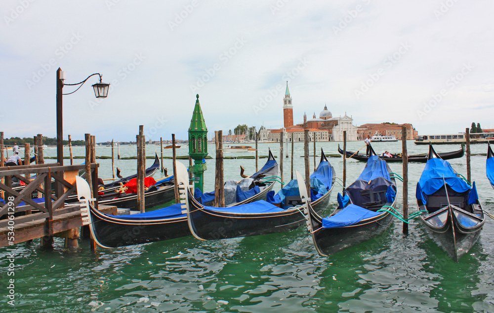 Cityscapes with gondolas in front of San Giorgio Maggiore church in Venice, Italy	