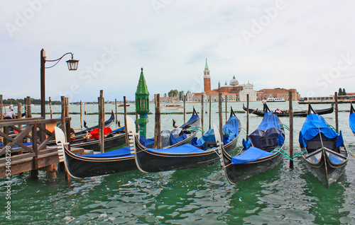 Cityscapes with gondolas in front of San Giorgio Maggiore church in Venice, Italy 
