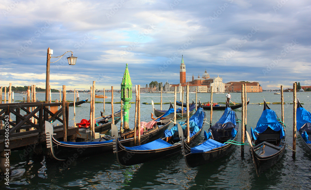 Cityscapes with gondolas in front of San Giorgio Maggiore church in Venice, Italy	