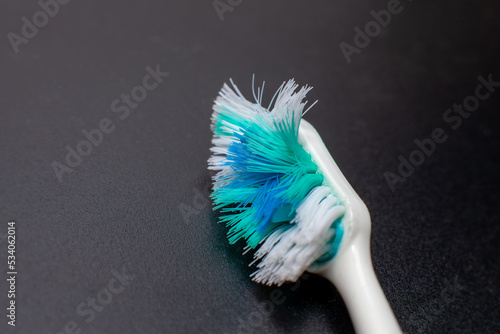 used toothbrush isolated on dark background