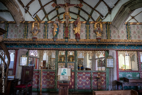 Screen and altar at the Church of St. Protus and St. Hyacinth at Blisland, Cornwall, UK with crucifix and statues