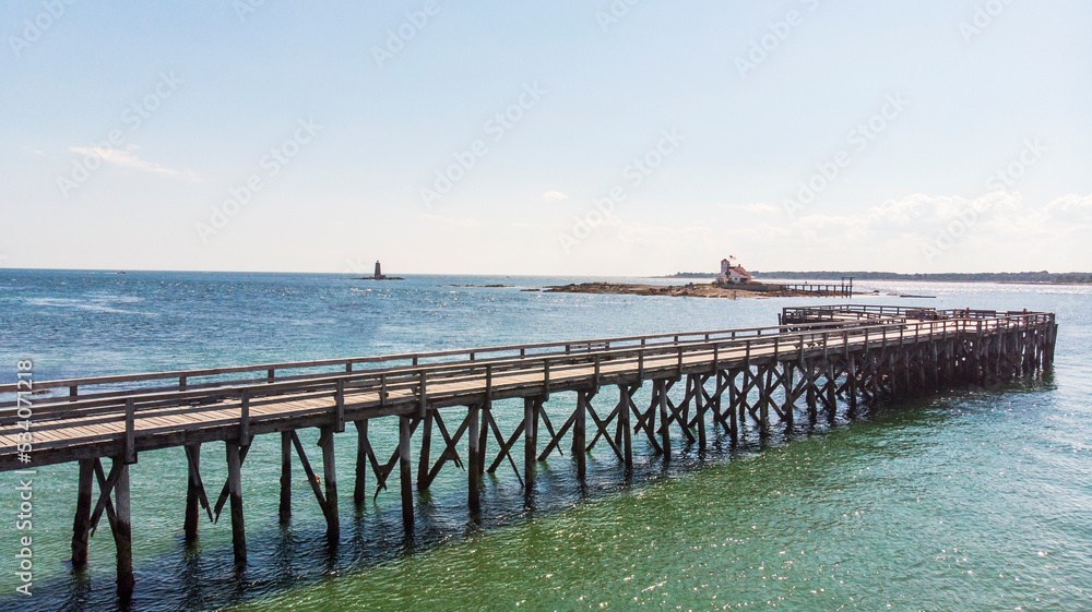 Wooden pier by the beach and ocean in the summer