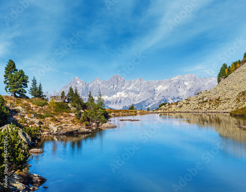 Calm autumn Alps mountain lake with clear transparent water and reflections. Spiegelsee or Mirror Lake, Reiteralm, Steiermark, Austria.