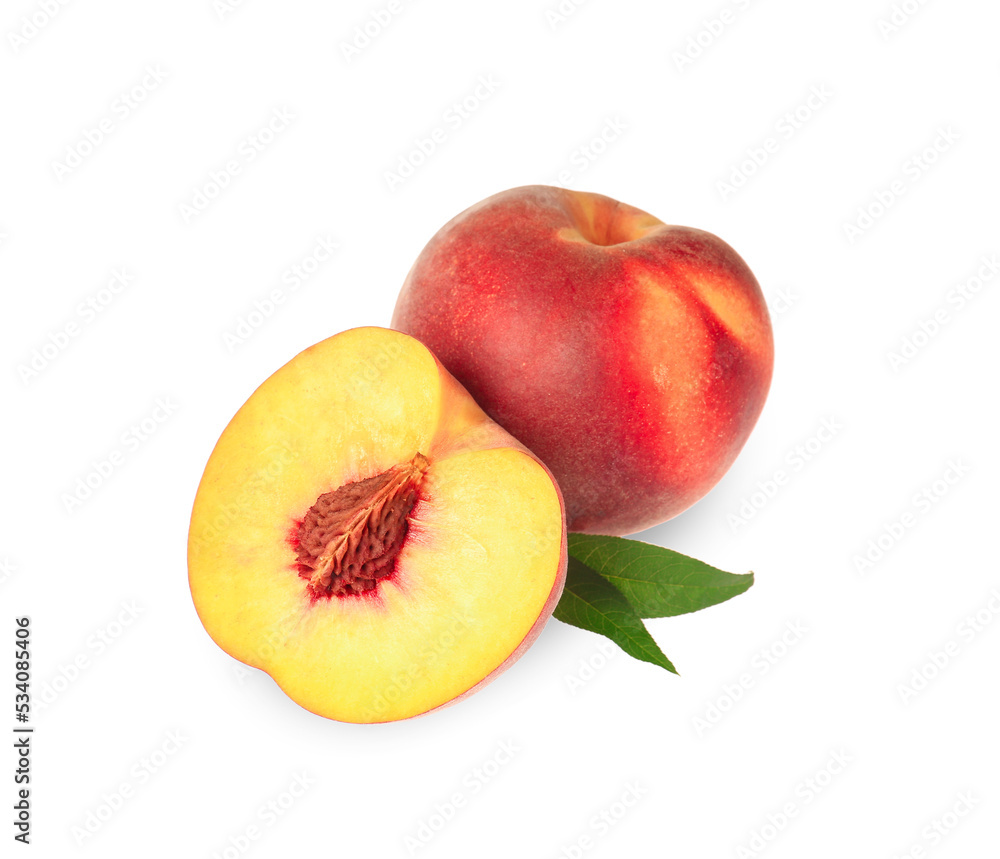 Whole and cut delicious peaches with green leaves isolated on white Whole and cut delicious peaches with green leaves isolated on white