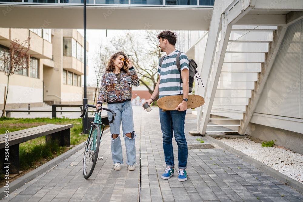 Fototapeta premium modern couple man woman male and female student talk in day outdoor
