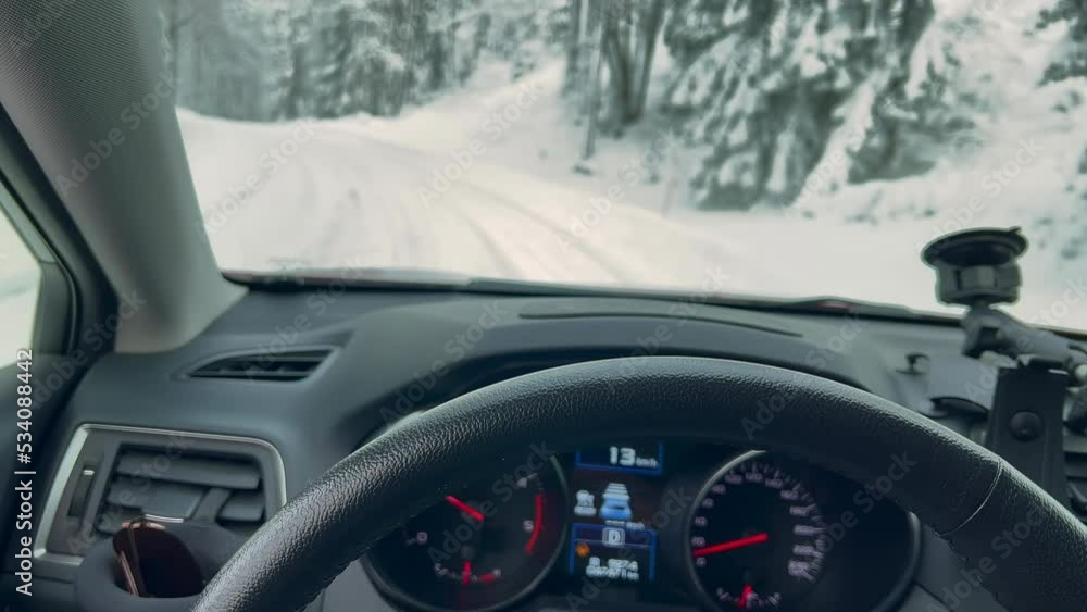 Driving in a snowy forest during the beautiful scandinavian winter. Amazing nordic nature. Trees and the road covered by thick snow. Camera slowly moving around. Driving in a snowy forest during the beautiful scandinavian winter. Amazing nordic nature. Trees and the road covered by thick snow. Camera slowly moving around.