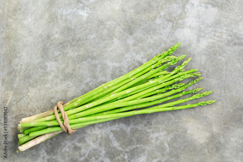 Vegetable healthy food bunch asparagus on stone background.