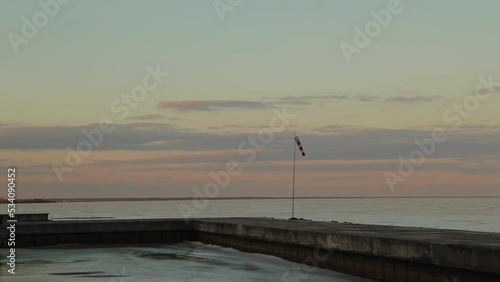 Frozen sea, pier, windsock, dawn