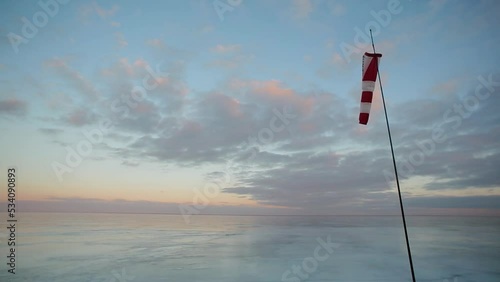 Frozen sea, windsock, beautiful sunset