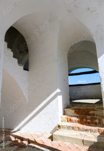 Arches and a column in the Bell Tower of the Crucifixion Church of the 16th century in Alexandrovskaya Sloboda in Alexandrov, Russia photo