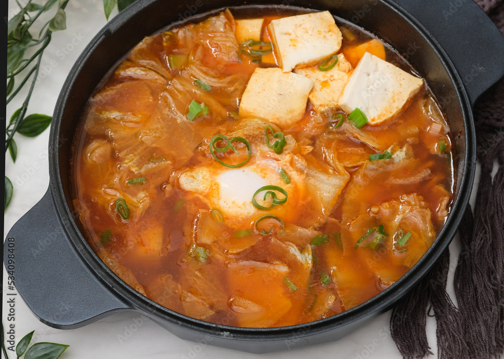 Korean spicy silken tofu stew which is called Sundubu Jjigae. Popular food in Korean Drama Korean spicy silken tofu stew which is called Sundubu Jjigae. Popular food in Korean Drama