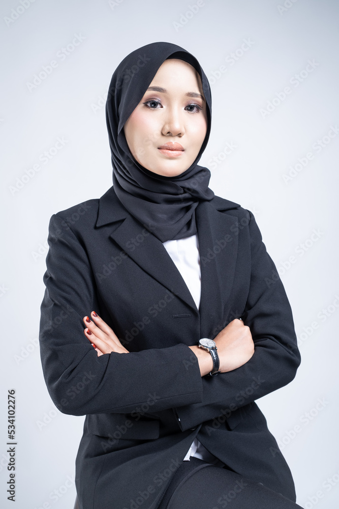 Portrait of an attractive Muslim woman wearing business attire and hijab with a corporate pose isolated on white background. For image cut-out for technology, business or finance. Portrait of an attractive Muslim woman wearing business attire and hijab with a corporate pose isolated on white background. For image cut-out for technology, business or finance.