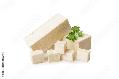 White tofu with parsley leaves on white background.
