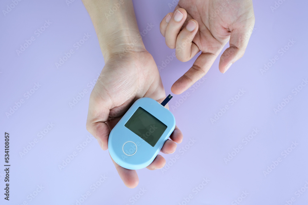 hand of people check diabetes and high blood glucose monitor with digital pressure gauge. Healthcare and Medical concept. hand of people check diabetes and high blood glucose monitor with digital pressure gauge. Healthcare and Medical concept.