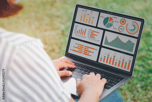 woman using laptop or notebook computer with data analysis graph dashboard, confident woman working with computer laptop concept, contact idea design dashboard graph business conceptual.