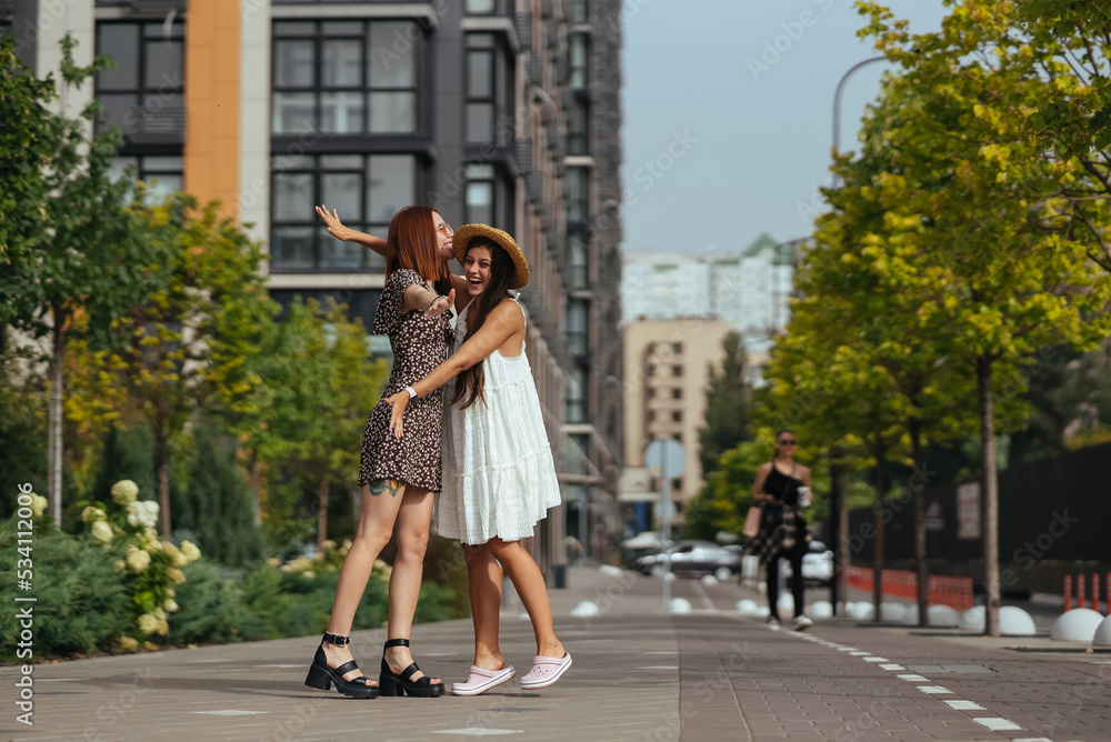 Happy meeting of two friends hugging in the street