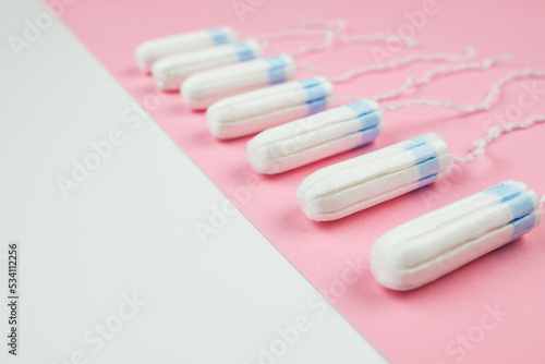 tampons on a pink and white background with copy space.