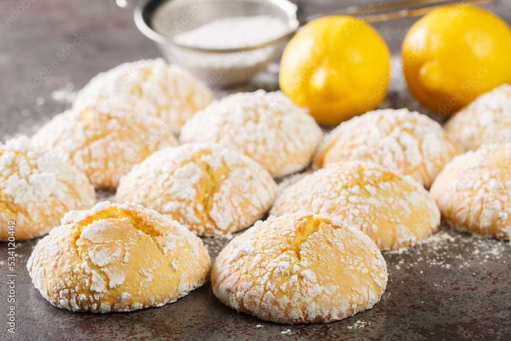Festive homemade cracked lemon cookies with powdered sugar close-up on the table. horizontal