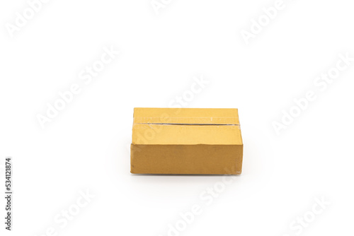 Isolated one brown paper box Postal Package from shopping online, is delivered to the buyer. It's shot in the studio light in front of white background. Clipping Paths.