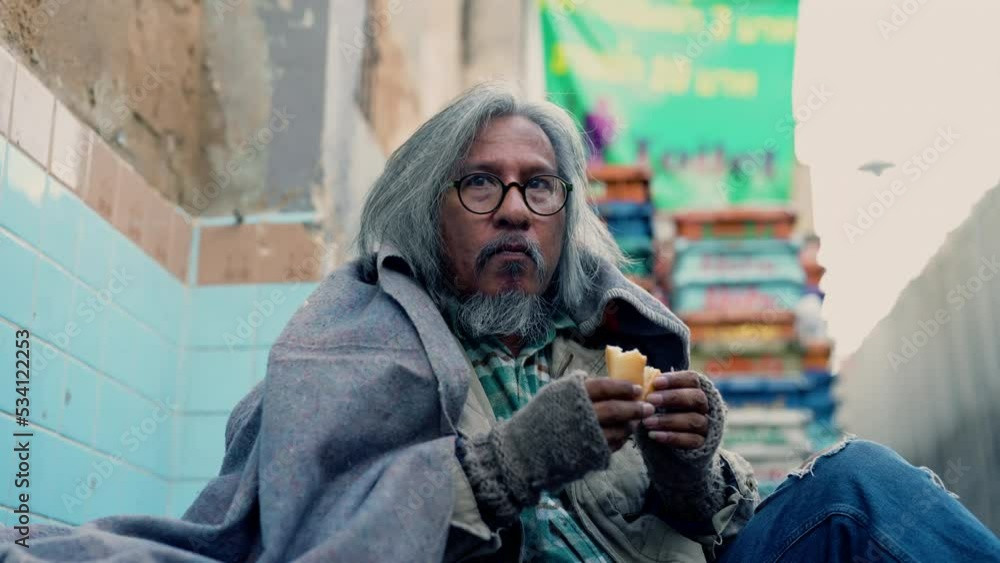 Homeless poverty man meet financial crisis sitting on street and eating bread, aged man crazy no home, no money, no job. society's economic problem abandoned hopeless elderly.
Homeless poverty man meet financial crisis sitting on street and eating bread, aged man crazy no home, no money, no job. society's economic problem abandoned hopeless elderly.