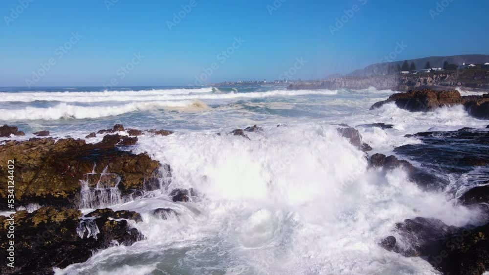 Angry ocean waves thrashing jagged shoreline in Hermanus, South Africa Angry ocean waves thrashing jagged shoreline in Hermanus, South Africa