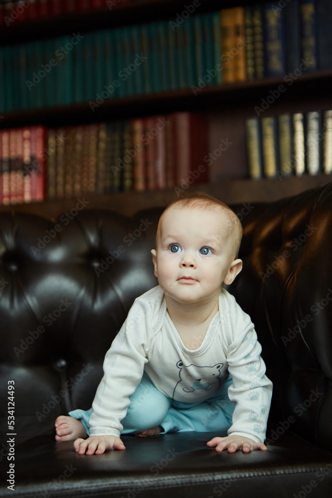 A small newborn baby is in a dark room. The concept of childhood A small newborn baby is in a dark room. The concept of childhood