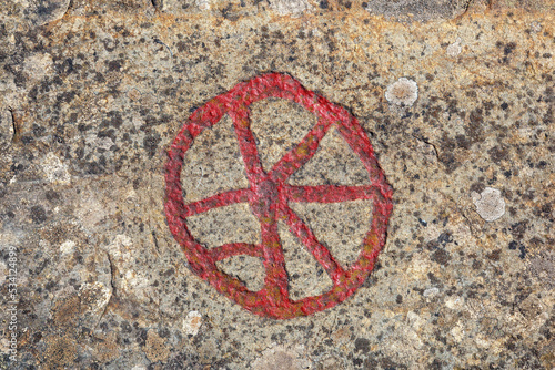 Wheel Petroglyphs figures on a rock photo