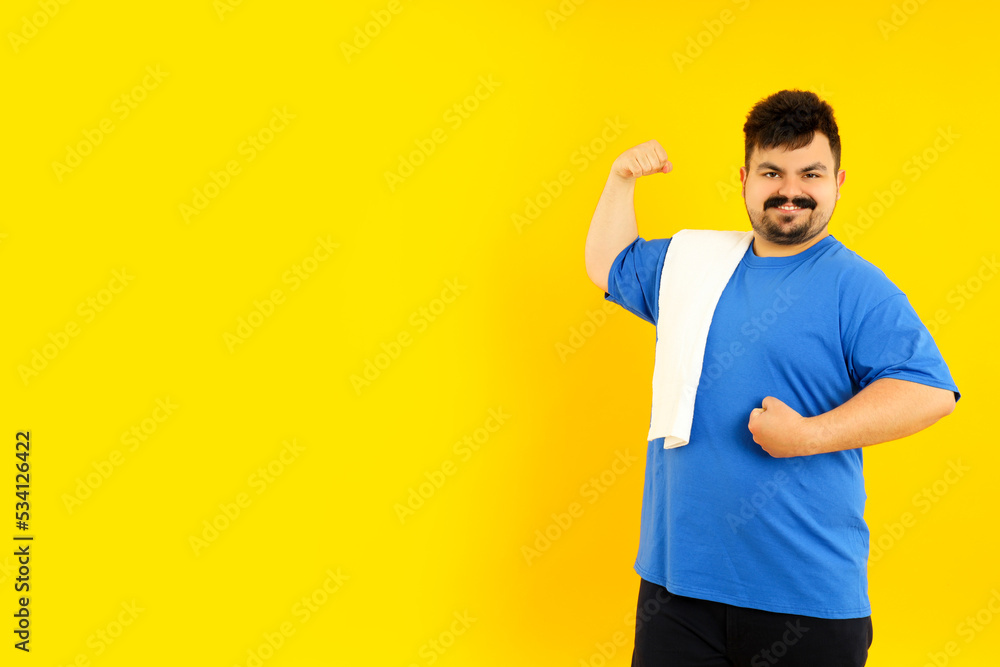Concept of people, young fat man on yellow background Concept of people, young fat man on yellow background