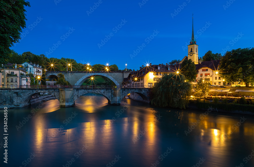 Fototapeta premium Image of historical bridges on the Aare River in Bern, capital city of Switzerland, during twilight blue hour.
