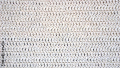 Handmade crochet knitted stitched yarn soft tender fiber fabric craft abstract wallpaper background backdrop