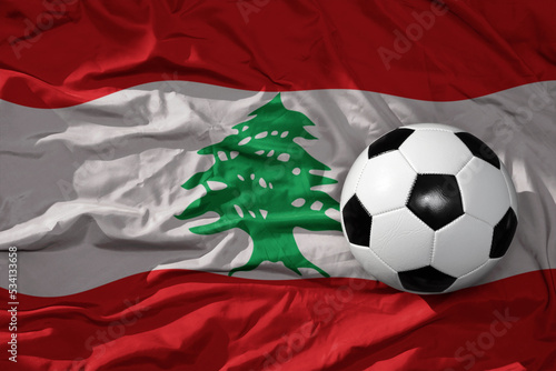 vintage football ball on the waveing national flag of lebanon background. 3D illustration