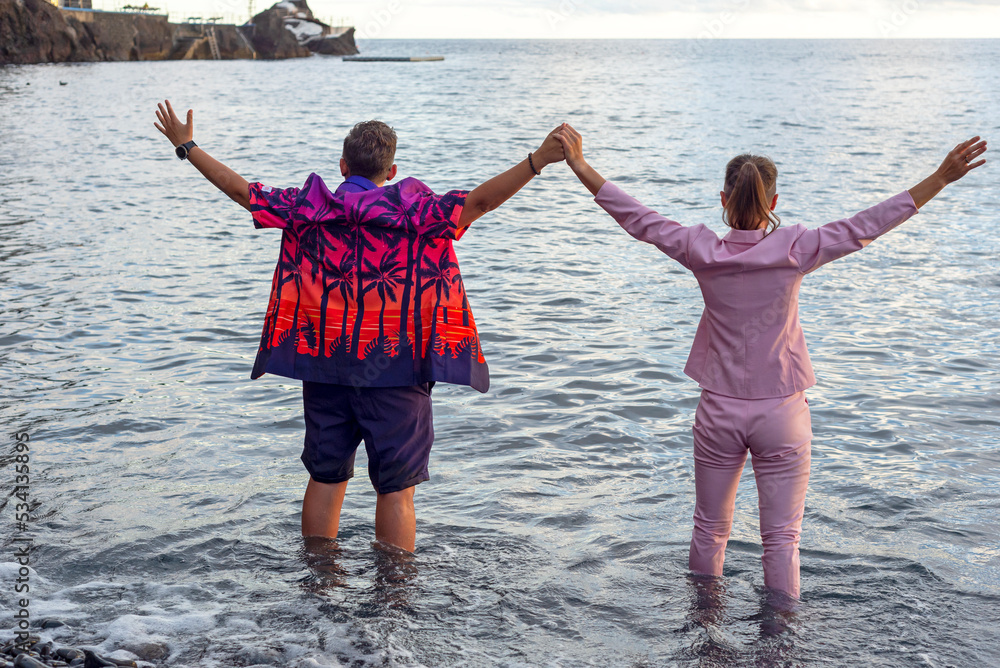 LGBT couple , two lesbians. Wedding, ocean, sea. They are holding hands.