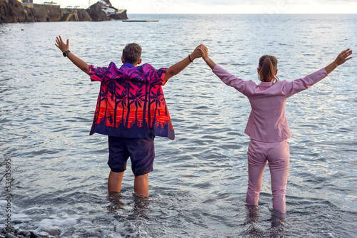 Obraz na płótnie LGBT couple , two lesbians. Wedding, ocean, sea. They are holding hands. w salonie