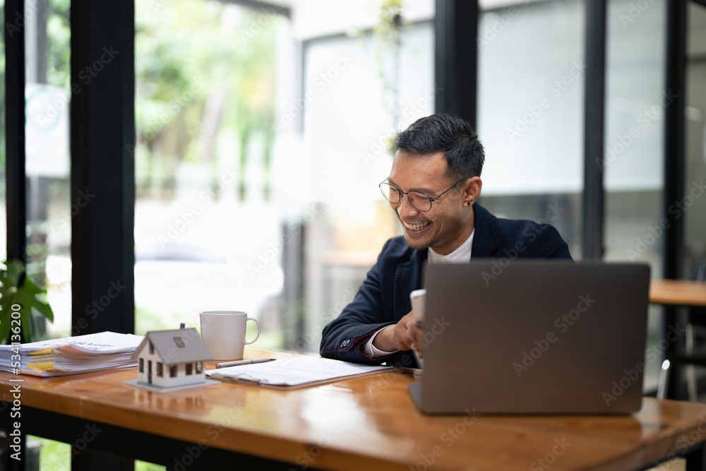 Business man agent calculating loan of finance and investment for real estate, businessman and invest in property about home, construction or mortgage of home, male using calculator. Business man agent calculating loan of finance and investment for real estate, businessman and invest in property about home, construction or mortgage of home, male using calculator.