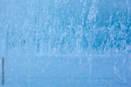 Texture of winter ice surface. Blue natural ice background