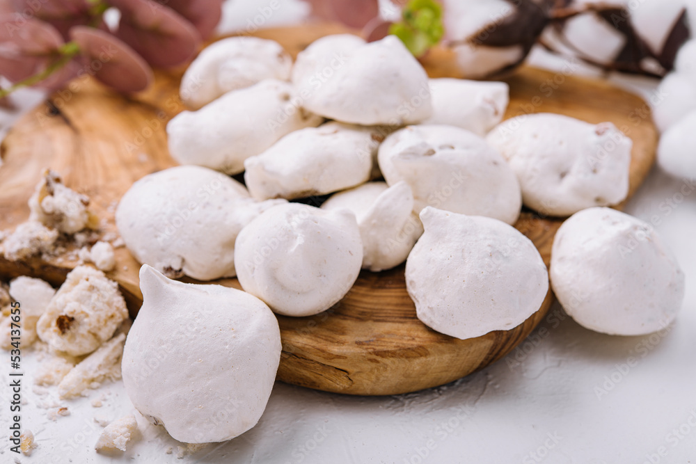 Fresh meringue cookies on wooden board Fresh meringue cookies on wooden board