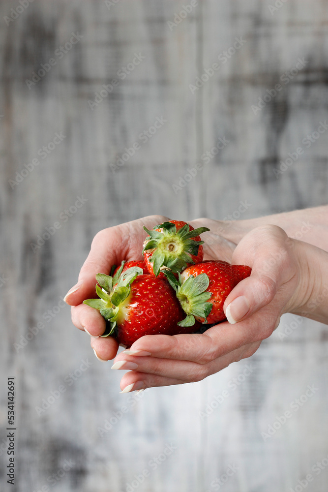 Fresh ripe strawberries in beautiful hands