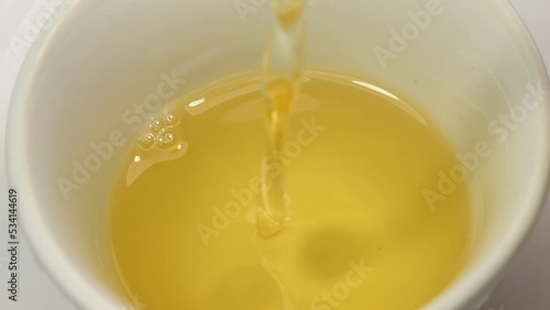 Japanese rice wine mirin running into a bowl