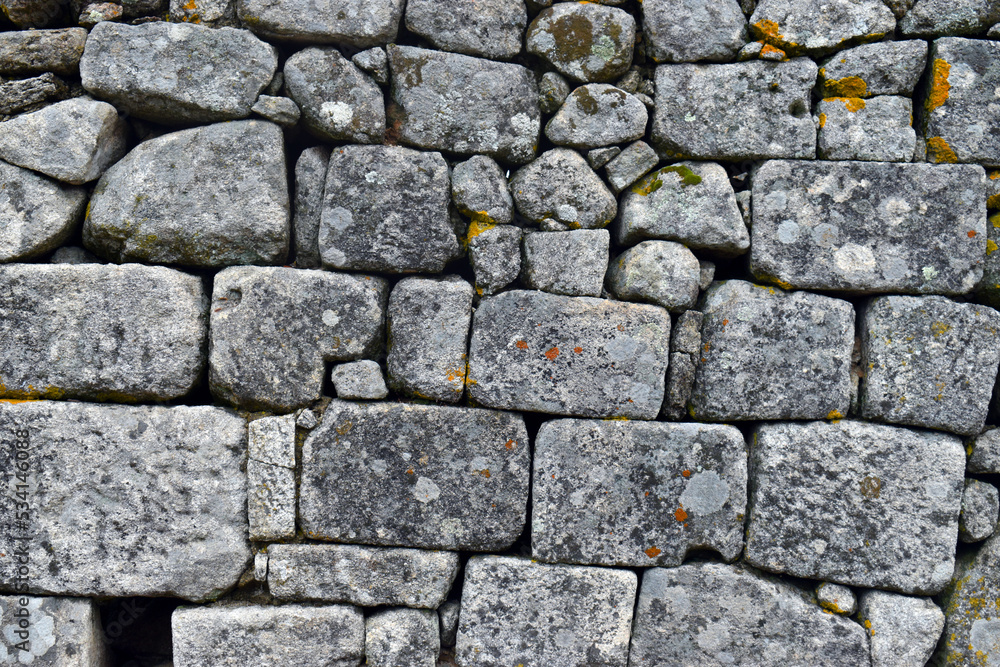 Fototapeta premium Wall formed by carved granite blocks