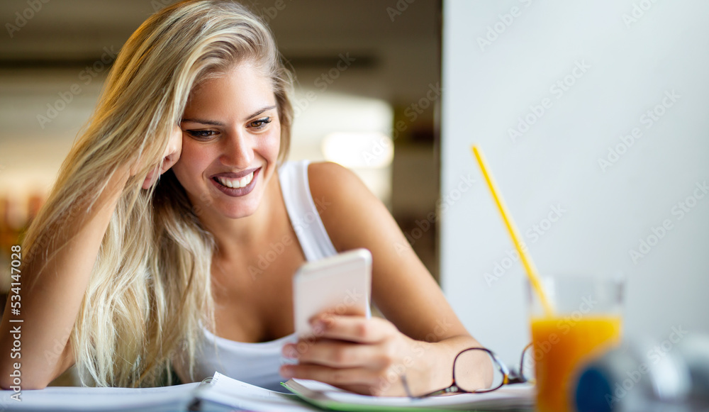 Happy young female using smartphone and having fun. Technology social media device people concept Happy young female using smartphone and having fun. Technology social media device people concept