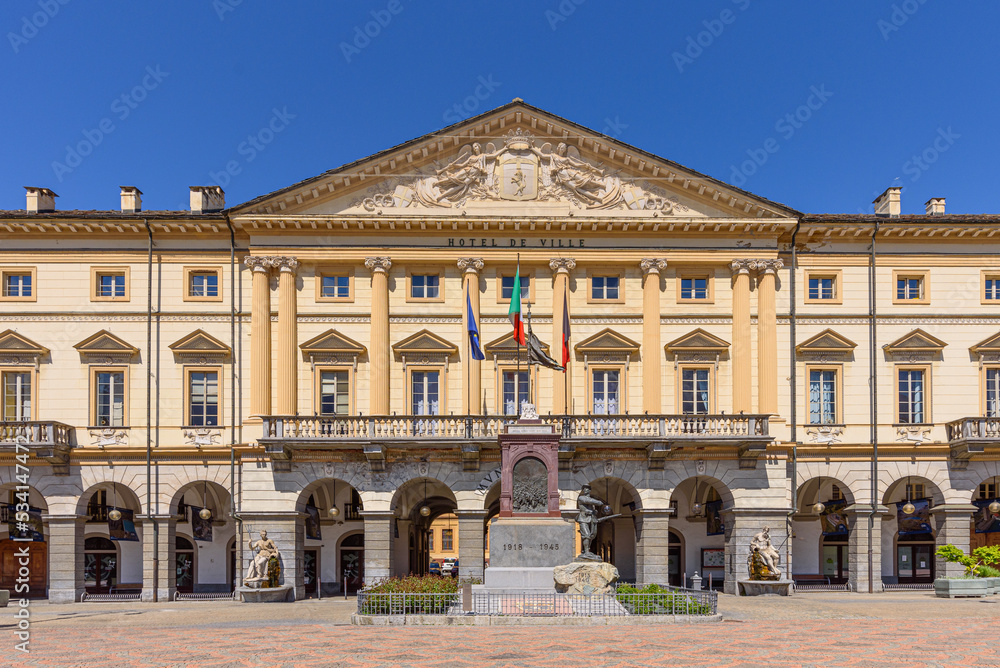 Aosta, Italy. View of the external facade of the City Hall in Émile Chanoux Square. In front of the building is the Monument to the Aosta Valley soldier. April 17, 2022.