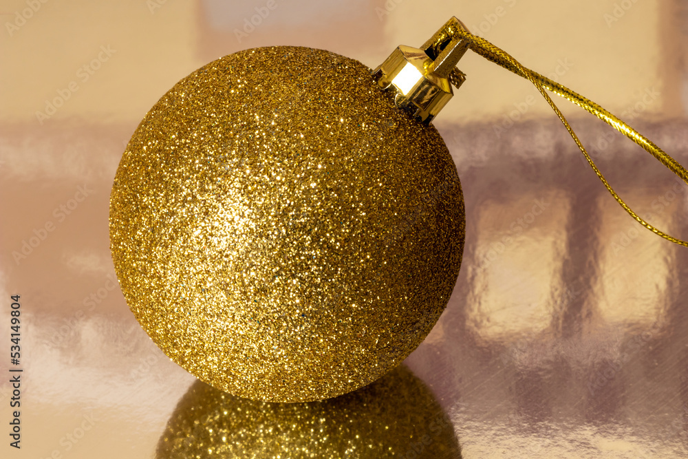 Golden Christmas ball. Close-up. A symbol of Christmas and New Year.