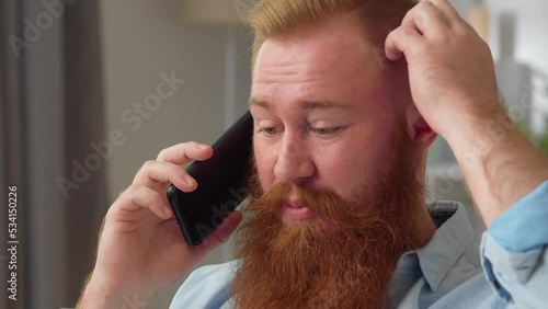 Young redhead man spend free time at home talking to friend or family remotely